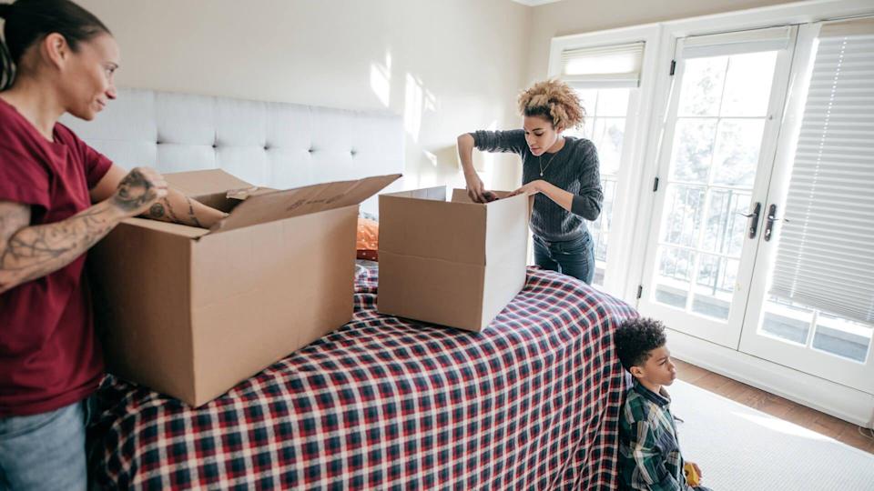 family filling boxes to move items out of house