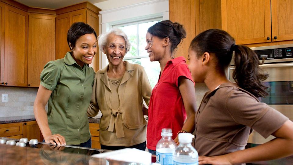 Multigenerational family talking in kitchen.