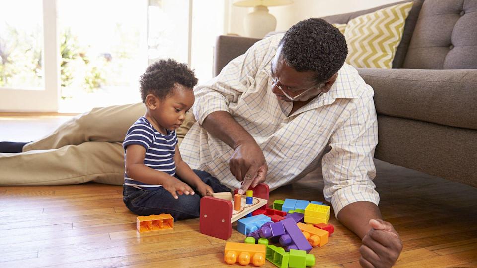 grandparent and young child playing with toys